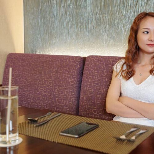 Disengaged guest sitting alone in restaurant, illustrating why personalised win-back emails are essential in hospitality marketing