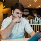 Restaurant manager reviewing email marketing results on a tablet, analysing why email marketing campaigns are failing to engage guests