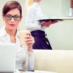 Restaurant manager reviewing landing page performance on laptop to improve booking conversions.