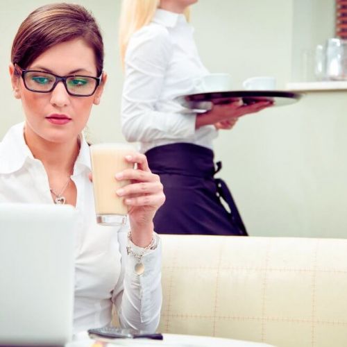 Restaurant manager reviewing landing page performance on laptop to improve booking conversions.