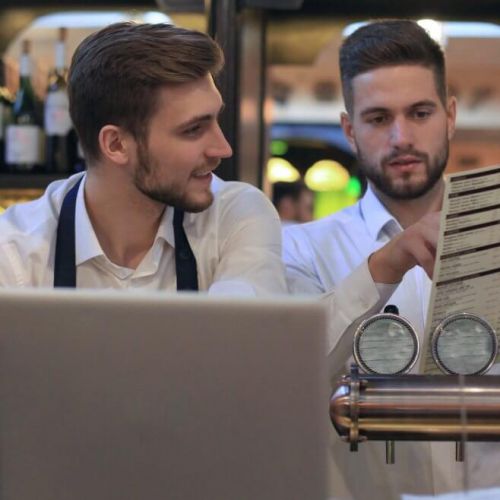 Restaurant managers discussing menu design mistakes that reduce sales and harm the dining experience